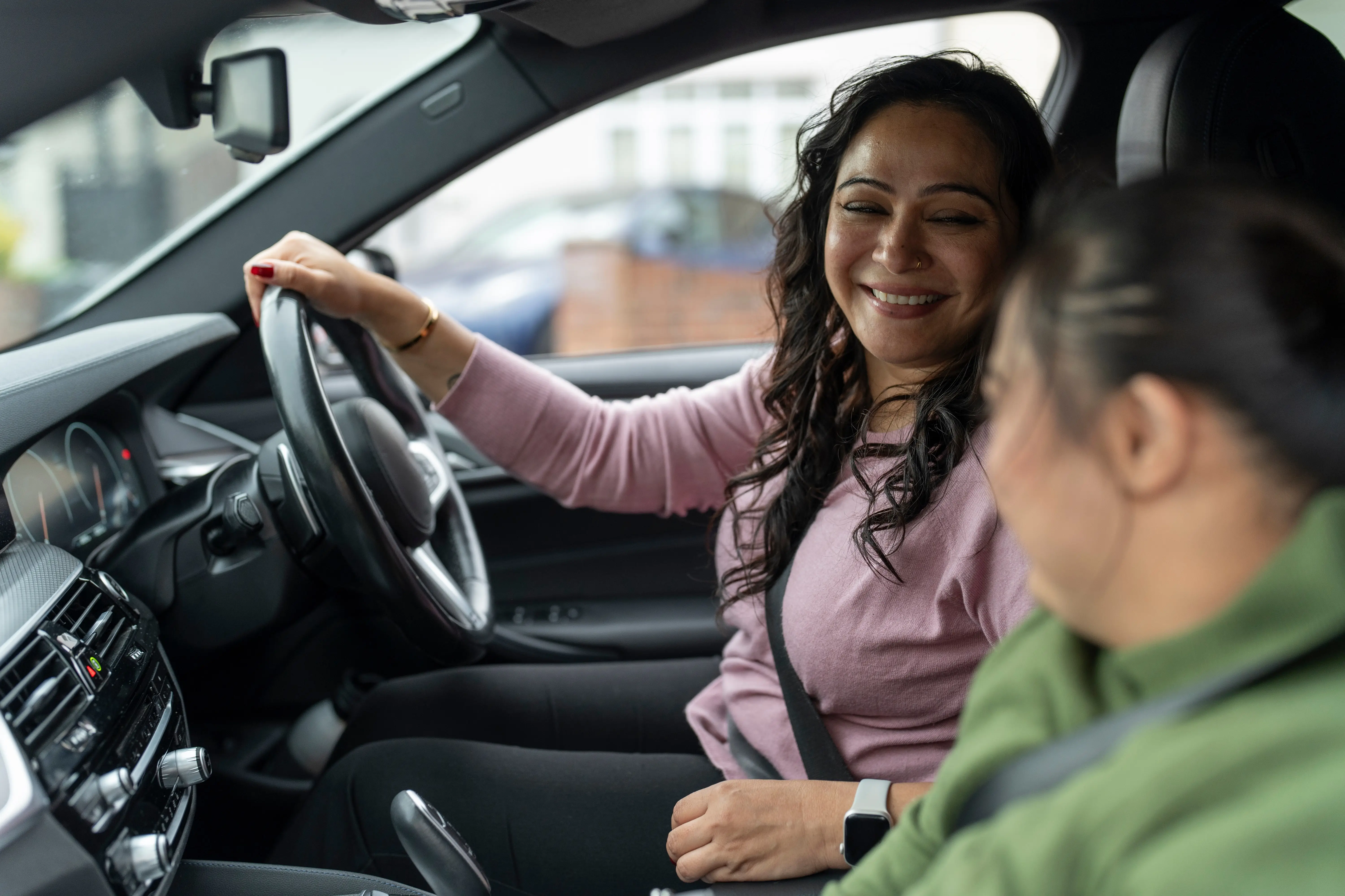 Mother driving car with down syndrome daughter
