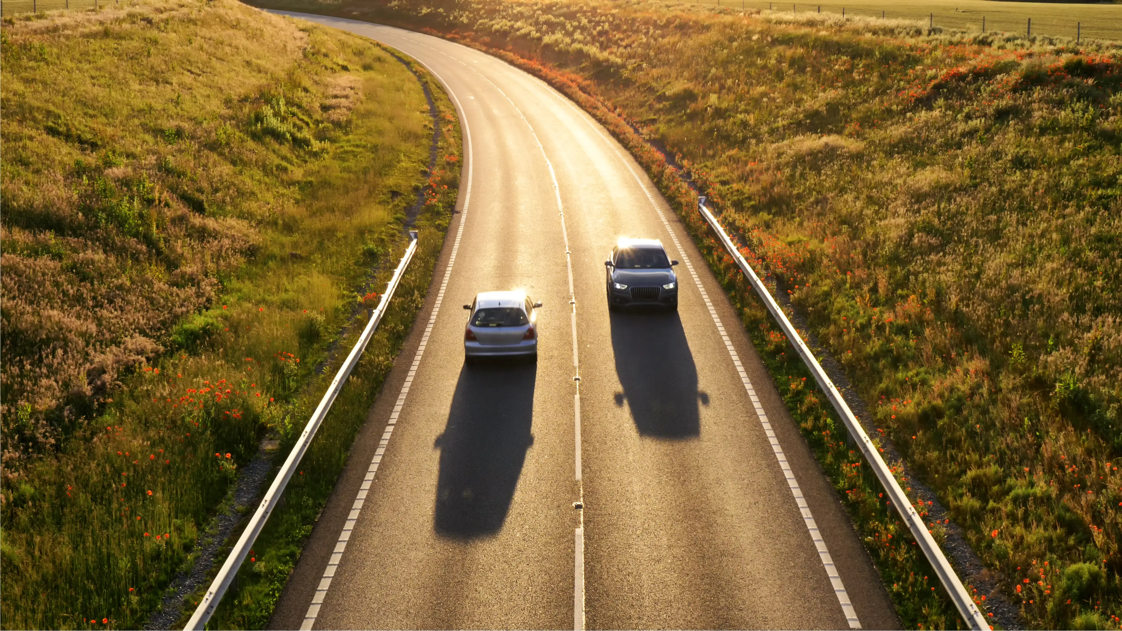 two cars traffic on uk motorway sunset view